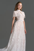 White architectural lace bustier A-line gown with mini cape and crystal embellishments by I.H.F Studio.