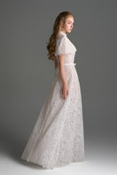 White architectural lace bustier A-line gown with mini cape and crystal embellishments by I.H.F Studio, elegant evening dress.