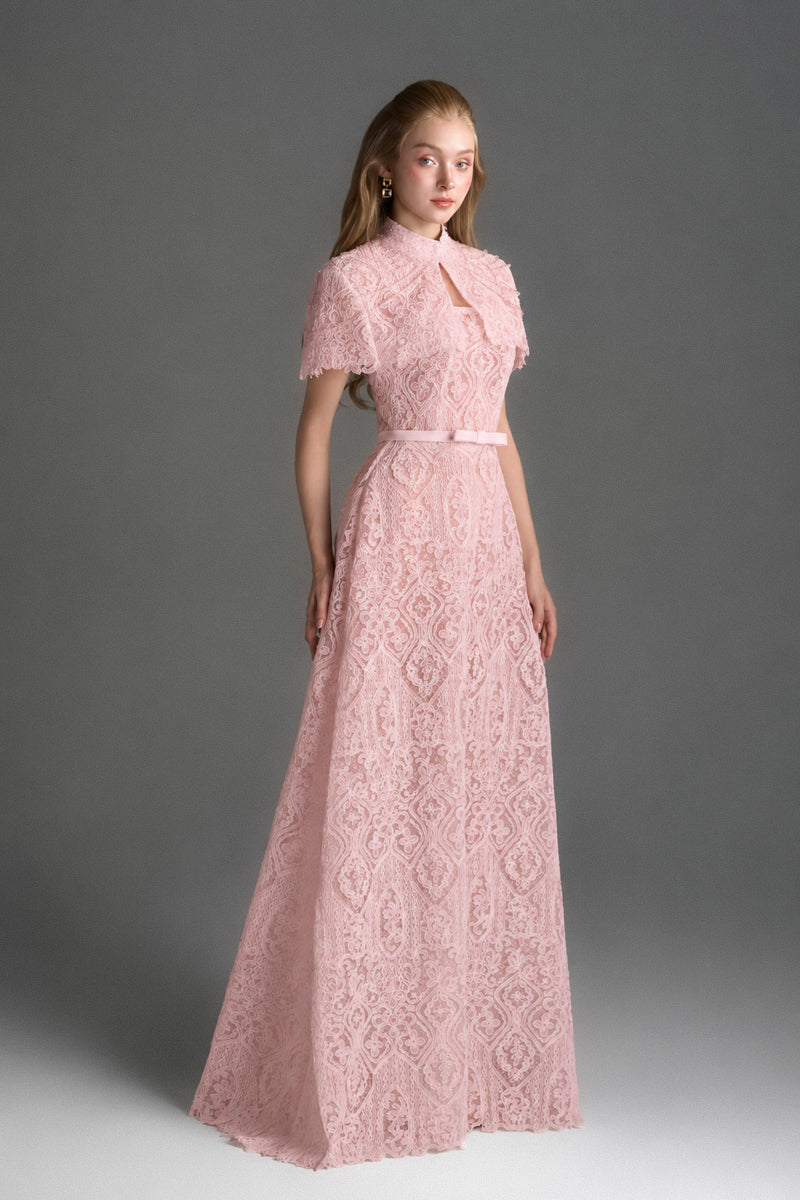 Light pink architectural lace bustier A-line gown by I.H.F Studio with mini cape and crystal embellishments.