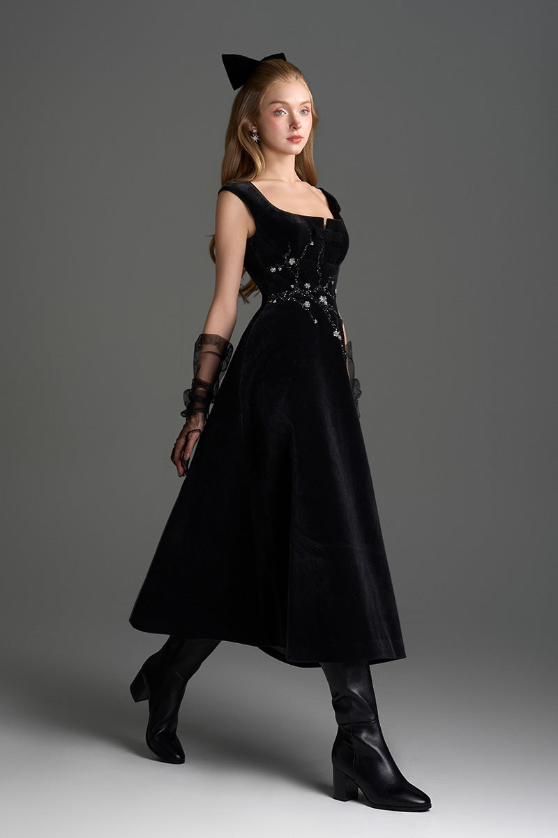 Black velvet A-line midi gown by I.H.F Studio featuring a sophisticated design with branch detailing on the dress.