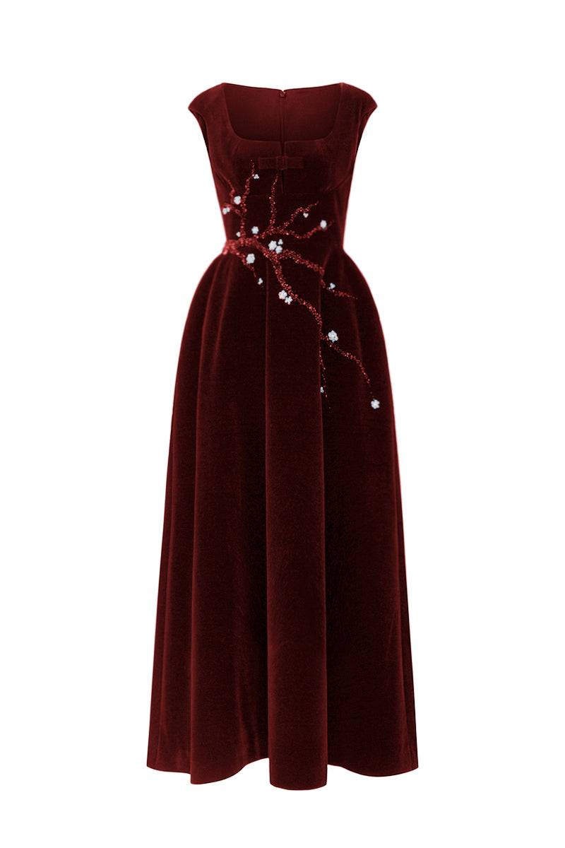 Red velvet A-line midi gown by I.H.F Studio featuring a sleek silhouette and elegant design, with a branch detail on the dress.