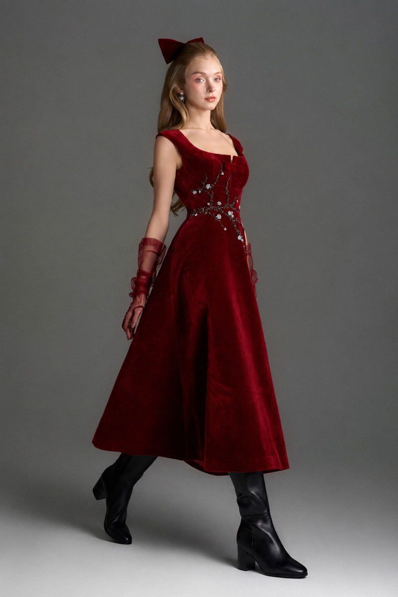 Red velvet A-line midi gown by I.H.F Studio featuring a sophisticated silhouette and elegant design, shown with a branch accessory.
