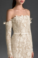 Ivory floral lace off-shoulder mermaid gown by I.H.F Studio with a silk waist belt, elegant and fitted for formal occasions.