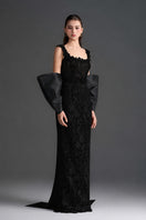 Black floral lace gown with square neckline and large back bow, designed by I.H.F Studio, featuring a sleek column silhouette.