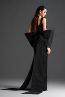 Black floral lace square-neck column gown with large back bow by I.H.F Studio, featuring intricate lace details and elegant design.