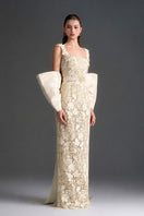 Ivory floral lace column gown with square neckline and large back bow by I.H.F Studio, perfect for elegant occasions.