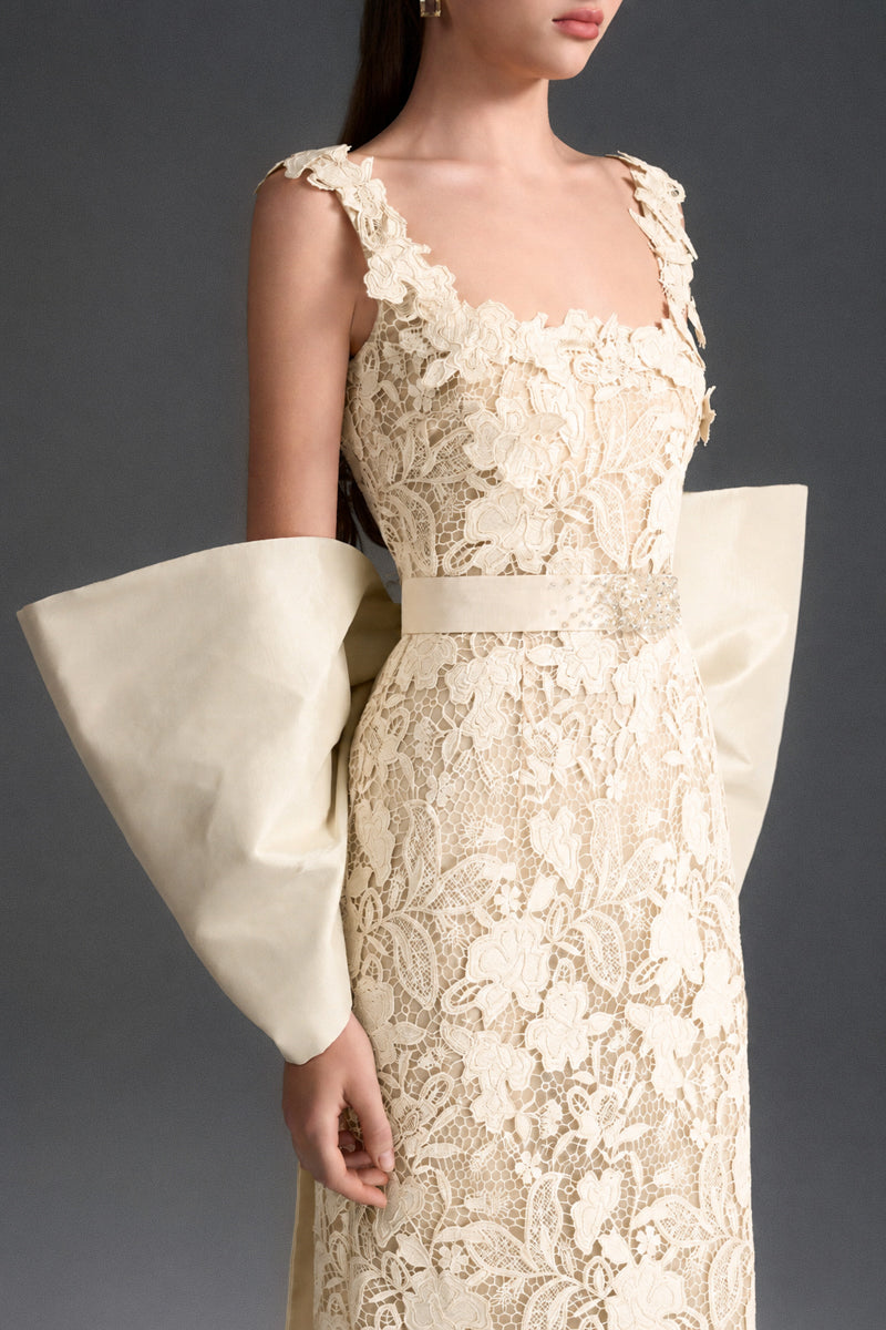 Ivory floral garden lace gown with square neck and large back bow, I.H.F Studio column dress perfect for elegant occasions.