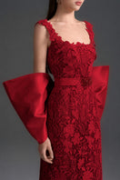 Red floral garden lace gown with square neckline and large back bow from I.H.F Studio, featuring a sleek column silhouette.