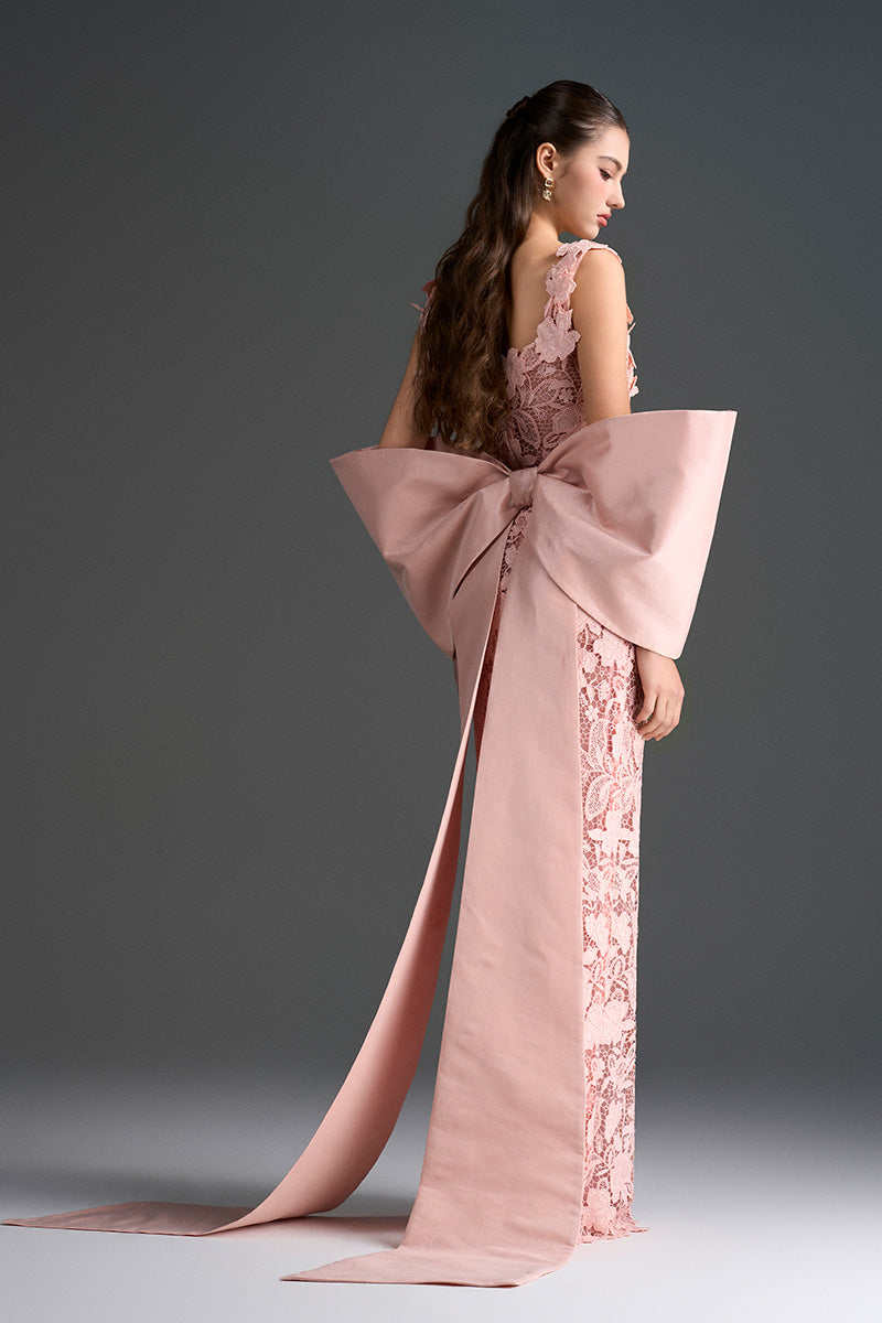 Light pink floral garden lace gown by I.H.F Studio featuring a square neck, column silhouette, and large back bow.
