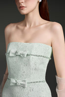 Elegant strapless lacquered brocade gown by I.H.F Studio featuring intricate patterns and a fitted silhouette.