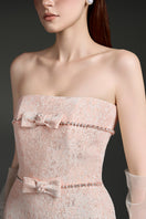 Elegant strapless lacquered brocade gown by I.H.F Studio featuring intricate patterns and a sleek, sophisticated silhouette.