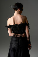 Black floral vine lace off-shoulder draped A-line gown by I.H.F Studio, featuring elegant floral lace details and flowing fabric.