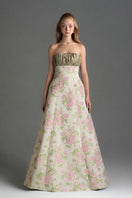 Light pink floral brocade and silk taffeta A-line gown by I.H.F Studio featuring clustered green and pink floral patterns.