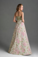 Light pink floral brocade and silk taffeta A-line gown by I.H.F Studio featuring clustered green and pink floral embroidery.