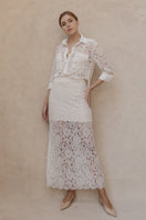 Entos ivory midi skirt with a flowing design, shown on a hanger, featuring a smooth fabric and elegant silhouette.