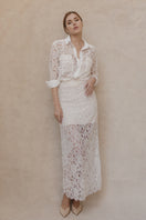 Entos ivory midi skirt with a flowy silhouette, shown on a model, featuring elegant fabric and stylish design.