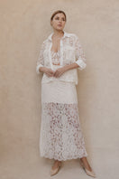 Ivory midi skirt by Entos featuring a sleek design and flowing fabric, perfect for casual or dressy occasions.