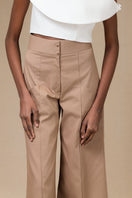 Tan Pino pants by ANA + MARIA displayed on a model, showcasing the stylish, tailored design and relaxed fit.