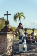 Maylé Vásquez CONSTA maxi dress in vibrant fabric, flowing design, and elegant style, shown on a model.