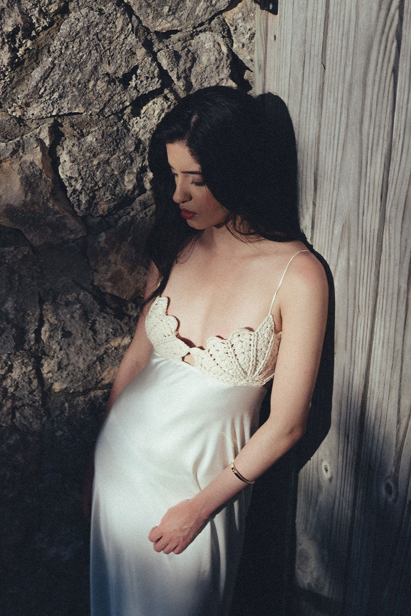 Elegant black Concha dress gown by Maylé Vásquez featuring intricate lace details and flowing fabric.