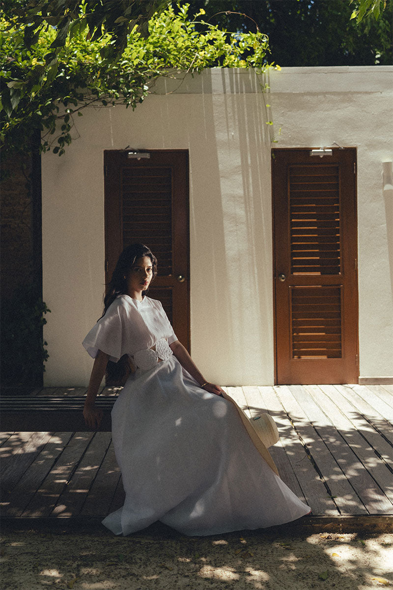 Elegant Maylé Vásquez circle gown with flowing fabric and intricate detailing, perfect for formal occasions.