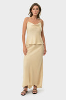 NiLuu cream cowl cami top, soft fabric with draped neckline, displayed on a hanger against a neutral background.