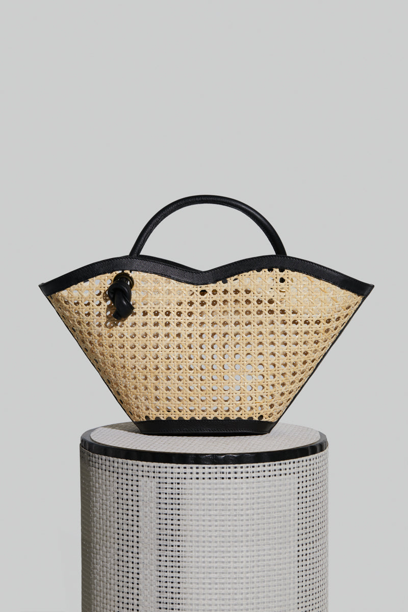 Black Cella Chair-inspired bag by Folklore The Label, featuring a sleek top handle design and modern style.