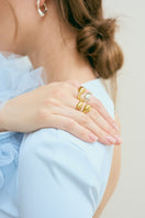 Gold CICLO ring by Eugenia Ospina, featuring a sleek circular design, shown on a neutral background.