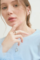 Silver CICLO ring by Eugenia Ospina featuring a sleek, minimalist design and smooth band, displayed on a neutral background.