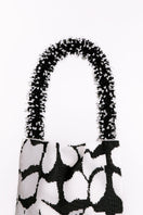 Close-up of SAC DE SOUL Clash of Prints black and white shoulder bag with bold, contrasting graphic design.