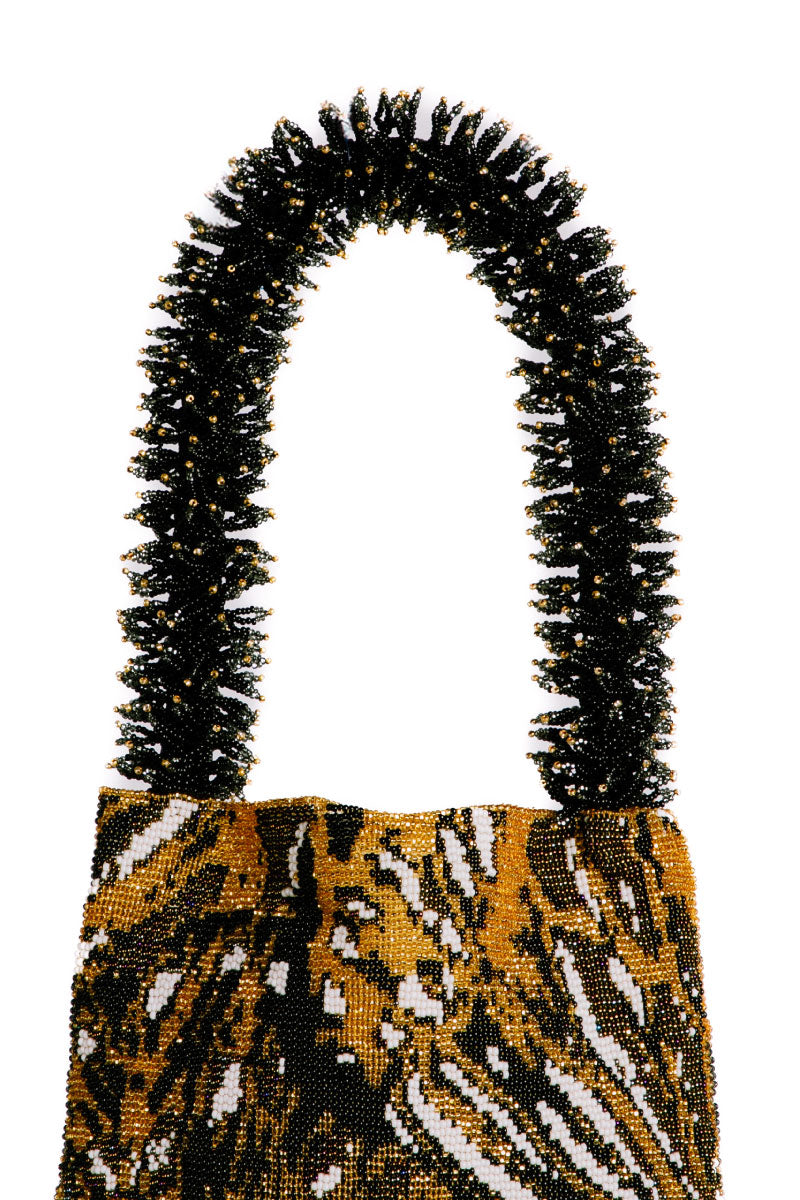 Close-up of SAC DE SOUL Clash of Prints Butterfly shoulder bag in gold, black, and white with bold printed design.