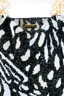Close-up of SAC DE SOUL Clash of Prints butterfly shoulder bag in black, cream, and white with bold print design.