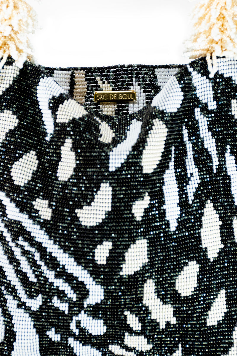Close-up of SAC DE SOUL Clash of Prints butterfly shoulder bag in black, cream, and white with bold print design.