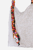 Close-up of SAC DE SOUL Serpent Big shoulder bag in white silver with red, orange, and pink accents.