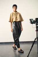 Black URA Lou pants displayed on a model, featuring a relaxed fit and stylish design, perfect for casual or chic outfits.