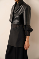 URA HANAH black jacket with a sleek design, featuring a fitted style and modern collar, shown on a plain background.