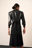 Black HANAH jacket by URA, stylish and comfortable outerwear with a sleek design, shown on a model.