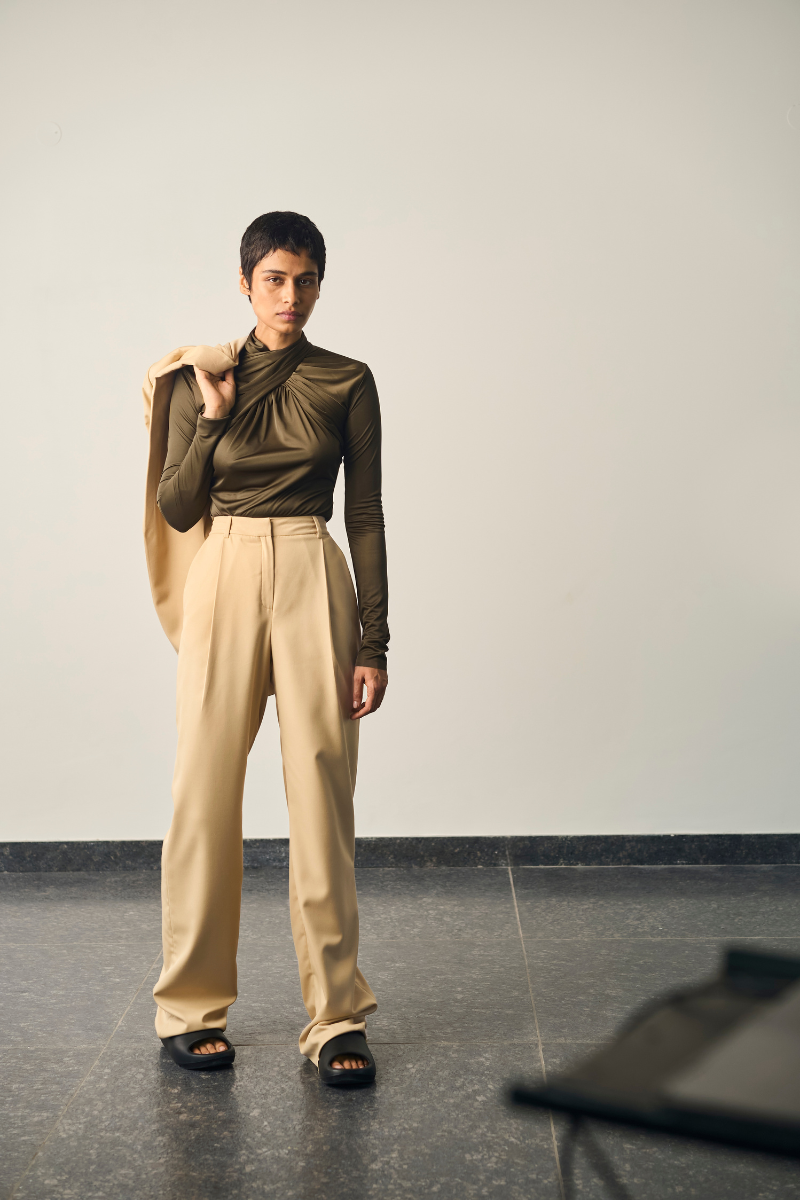 Olive green Laura bodysuit by URA, featuring a fitted design and long sleeves, displayed on a neutral background.