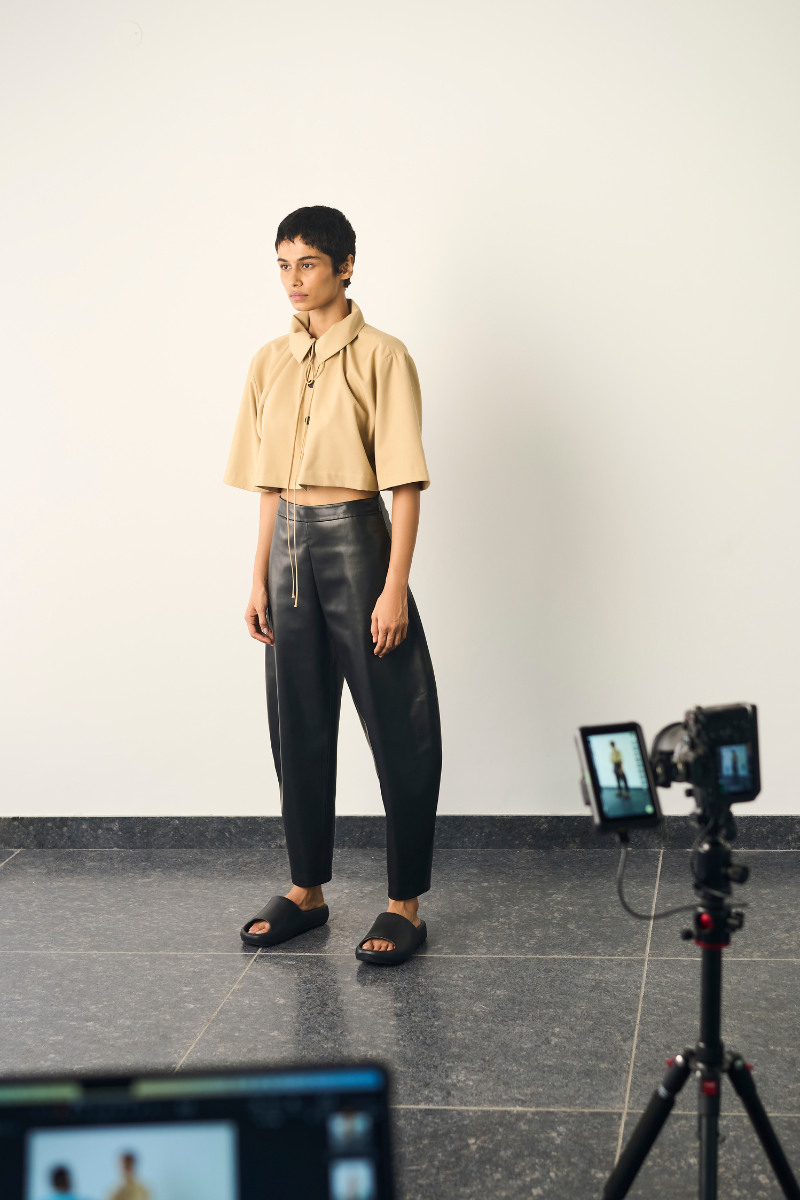 Black URA Lou pants with a tailored fit, featuring clean lines and a modern design, shown on a neutral background.