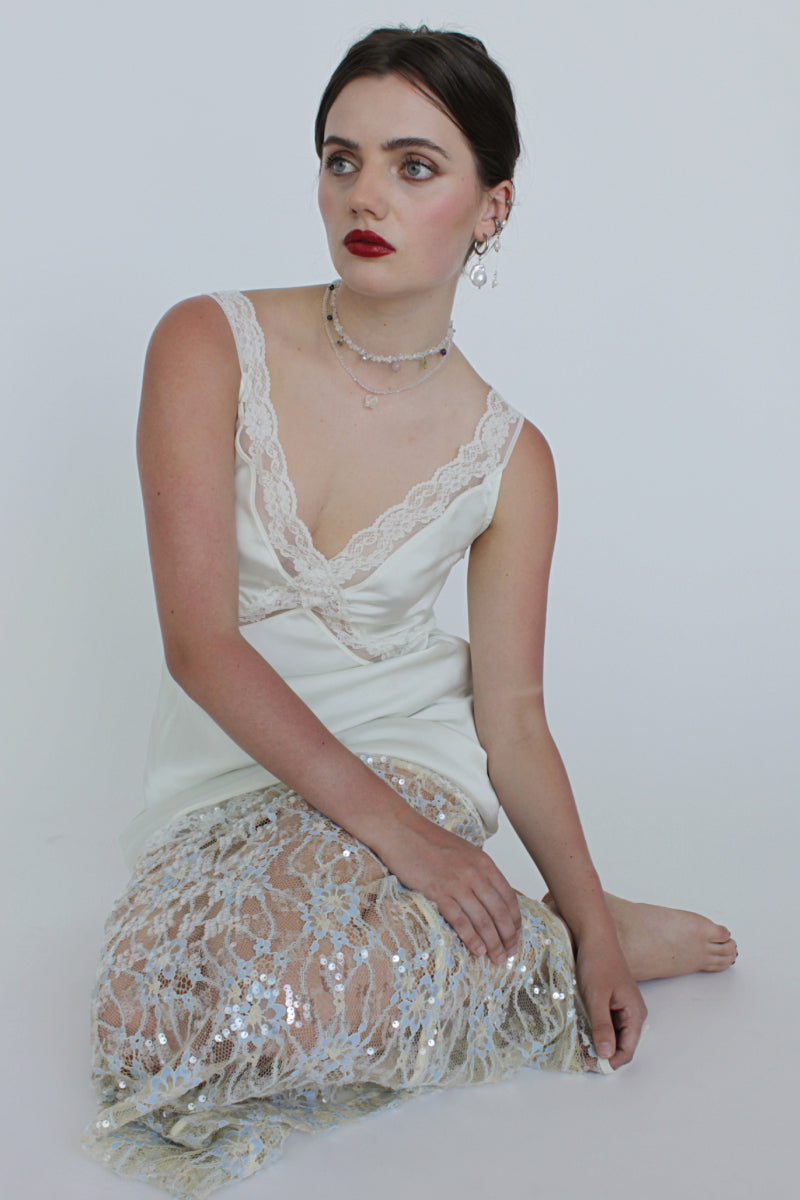 Aethera Alfonso Mix Charms Necklace in white with various decorative charms on a delicate chain.