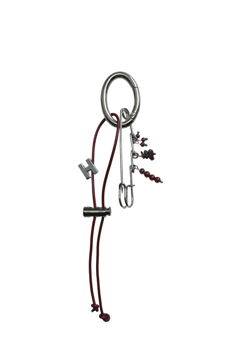 Red KAI Initial Bag Charm by Aethera, a jewelry set featuring a stylish initial pendant for bags or accessories.