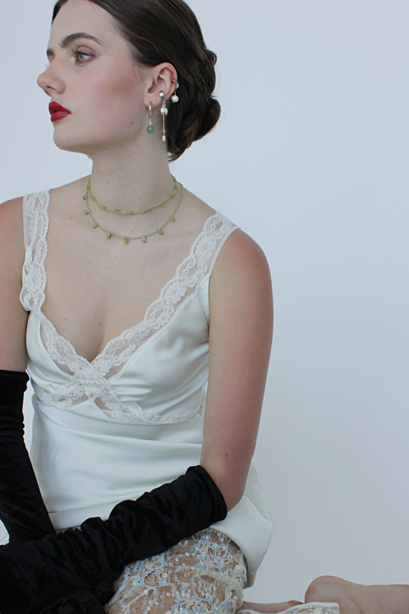 Aethera Soraia Peridot Necklace in green featuring a delicate chain and a vibrant peridot gemstone pendant.