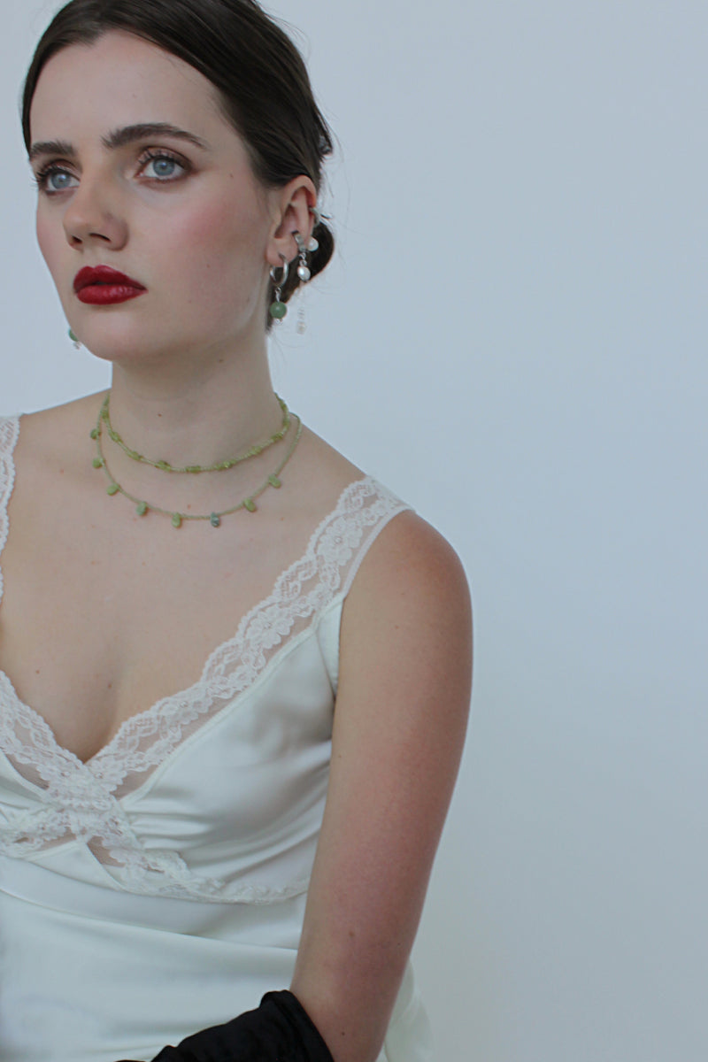 Aethera Soraia Peridot Necklace in green with a delicate chain and a vibrant peridot gemstone pendant.