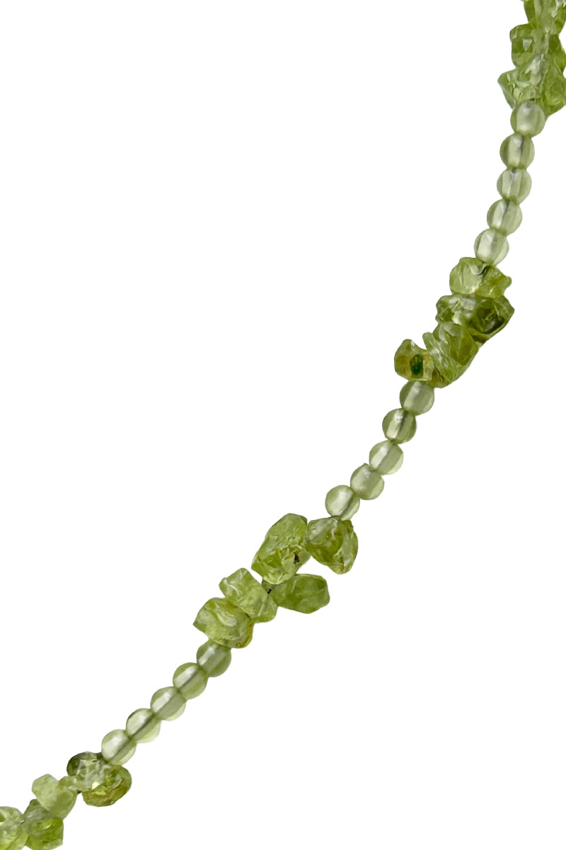 Aethera Soraia Peridot Necklace in vibrant green with a delicate chain and pendant, showcasing elegant jewelry design.