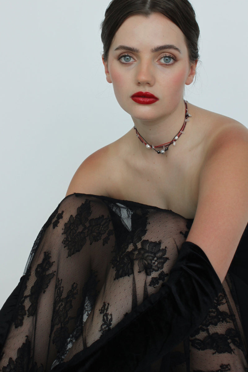 Aethera TUXI Garnet and Clear Quartz necklace featuring a striking red gemstone pendant on a delicate chain.