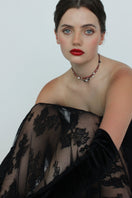 Aethera TUXI Garnet Clear Quartz Necklace in red featuring a polished gemstone pendant on a delicate chain.