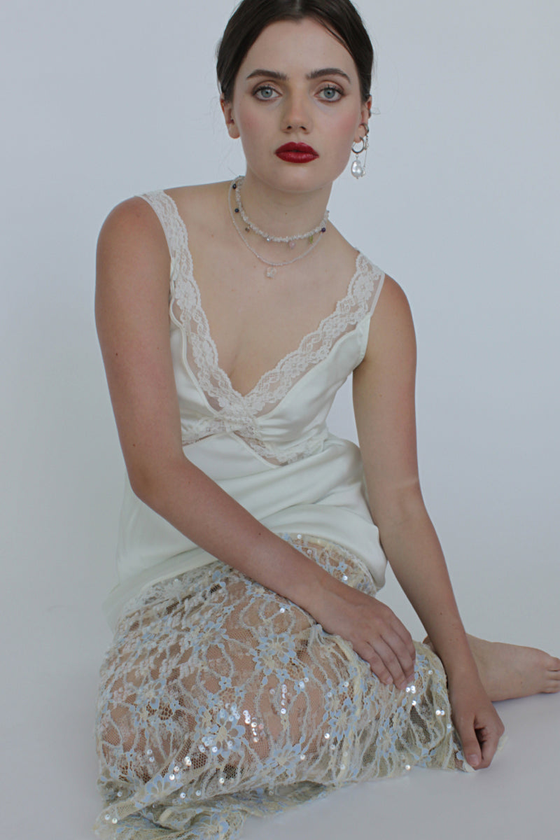 Aethera Alfonso Mix Charms Necklace in white with various silver-toned charms on a delicate chain.