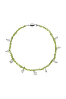 Aethera Toru Peridot necklace featuring a vibrant green gemstone pendant on a delicate chain.