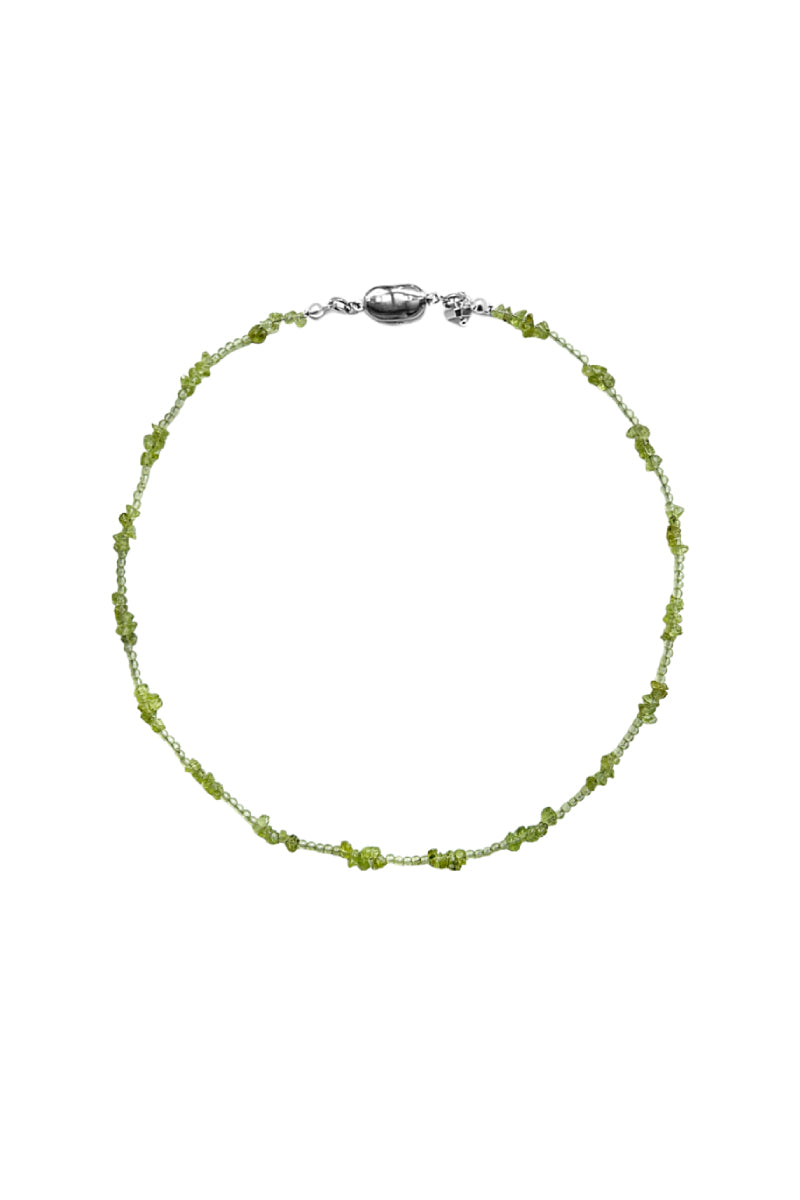 Aethera Soraia Peridot Necklace in green with a delicate chain and a round peridot pendant.