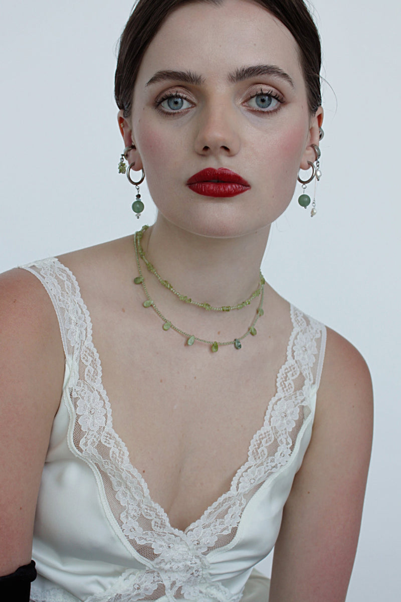 Aethera SORAIA Peridot Necklace in green with delicate chain and vibrant peridot gemstone pendant on a white background.